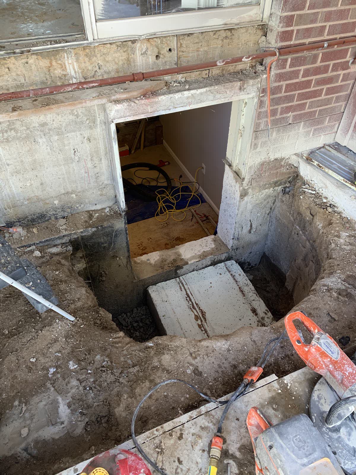Foundation opened up for repair under a brick house